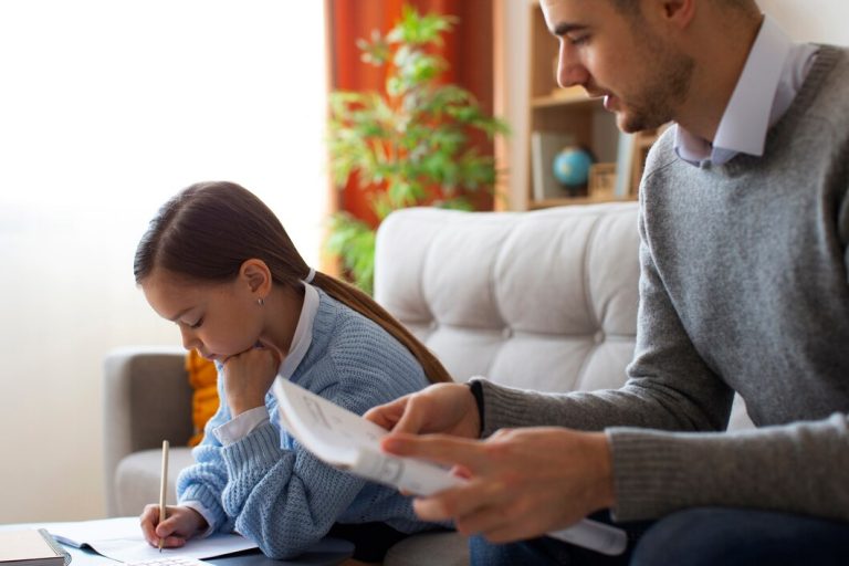 An adult sits on a couch holding papers while a young girl writes in a notebook at a table, both focused on their tasks—perhaps discussing Texas child support laws or related paperwork.