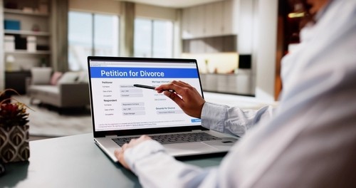 person pointing at Petition for Divorce online form on laptop screen